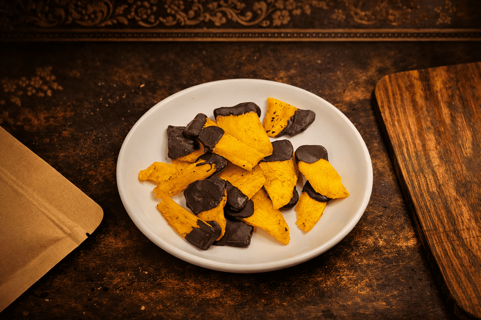 Top-down view of chocolate-dipped mango slices on a plate
